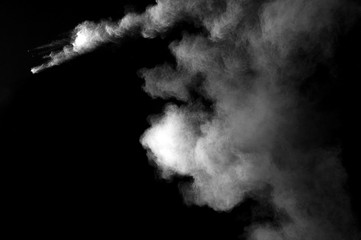 Freeze motion of white dust explosion on black background. Stopping the movement of white powder on...