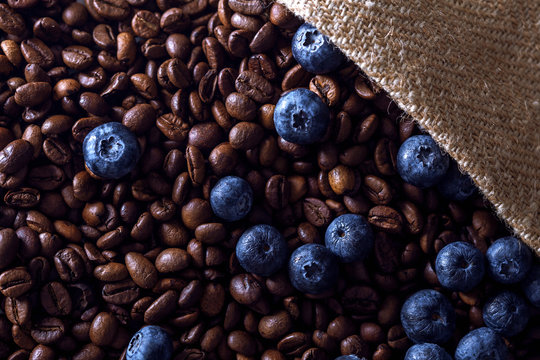 Roasted coffee beans with blueberries in a bag