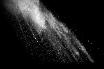 Freeze motion of white dust explosion on black background. Stopping the movement of white powder on dark background. Explosive powder white on black background. - 165842057