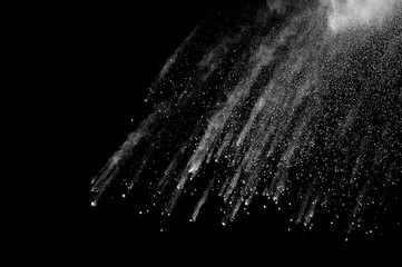 Freeze motion of white dust explosion on black background. Stopping the movement of white powder on...