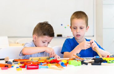 Fototapeta premium two child boy play repair toys