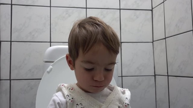 Mobile features on face of a child in toilet