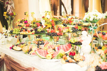 Various sweet sliced fruit on a buffet table