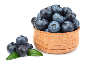 blueberries in wooden bowl isolated on white background