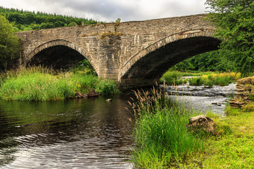 Fototapeta na wymiar Old stone bridge over river Dee, Wales