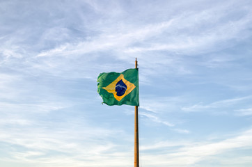 Old Brazilian flag waving on the wind