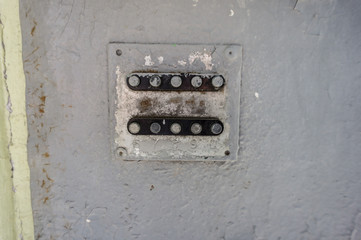 Peeling rough grey over paint wall with combination lock with handle on a metal surface , texture, background