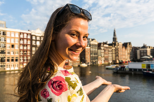 Tourist Girl On Sunset At The Damrak Square In Amsterdam