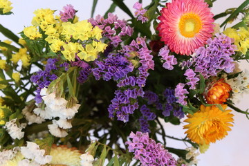 A bouquet of brightly colored flowers Helipterum and Limonium sinuatum.