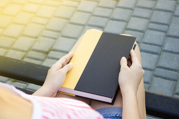 Obraz premium Top view of a woman holding a book.