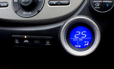 Digital controller display of air conditioner in car interior with twenty-five temperature climate...