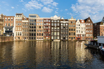 Fototapeta na wymiar Exterior view of buildings at Damrak street in the old town part of Amsterdam