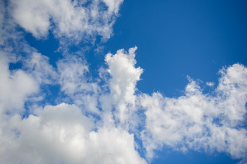 Big blue sky and white clouds. Background of celestial space. Beautiful soothing view of the firmament.