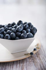 Fresh blueberries in white bowl