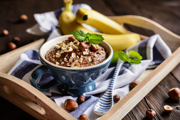 Oatmeal porridge with banana, hazelnut, chocolate and honey
