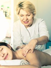 Obraz na płótnie Canvas Girl having professional massage in spa salon