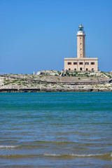 Fototapeta na wymiar Lighthouse from the coast of Vieste on a sunny day, Puglia region, Italy