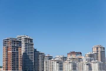 Fototapeta na wymiar High-rise modern buildings on the river bank
