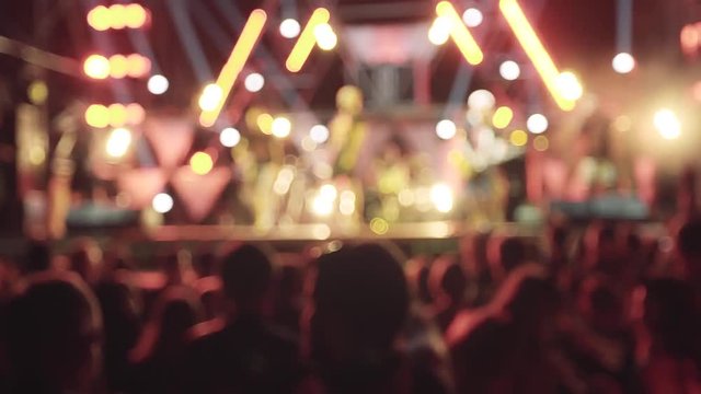 People crowd partying at a concert in slow motion