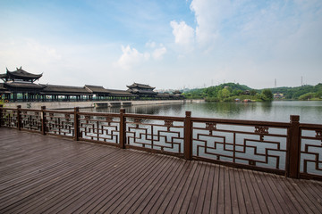 Naklejka premium Empty wood flooring with ancient architecture on the lake side