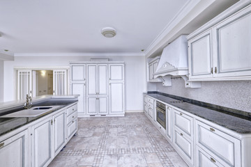 Modern design white kitchen in a spacious apartment.