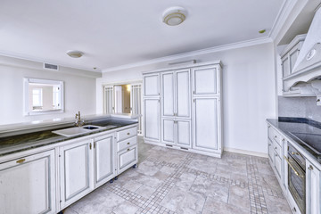 Modern design white kitchen in a spacious apartment.