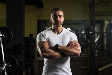 Naklejka na ściany i meble Portrait Of A Muscular Man In White T-shirt