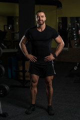 Fototapeta na wymiar Portrait Of A Fitness Man In Black T-shirt
