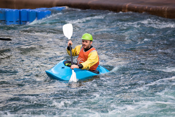 Naklejka premium Man with paddle in a kayak on the water