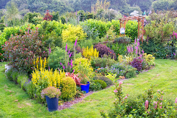 Very colourful British formal garden with mixed border of flowers and shrubs