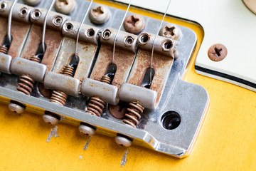 closeup of vintage guitar bridge and finish crack