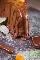 Chocolate dessert with orange chips on a wooden background