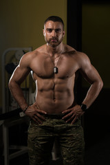 Fototapeta na wymiar Portrait Of A Muscular Man In Army Pants