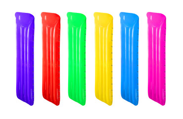 Set of multicolored inflatable floating pool raft mattress isolated on white.