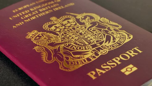 United kingdom passport on black desk, freedom of movement brexit concept focus pull