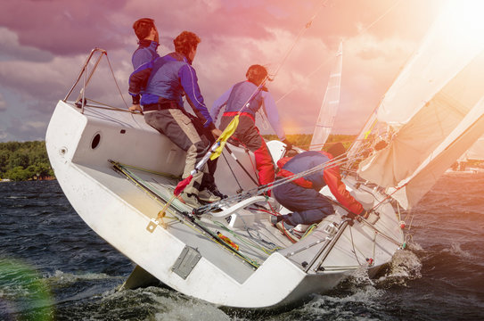 Sailing yacht race, regatta. Recreational Water Sports, Extreme Sport Action. Healthy Active Lifestyle. Summer Fun Adventure. Hobby.  Team athletes participating in the sailing competition
