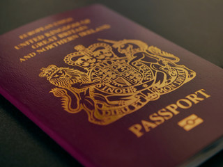 United kingdom passport on black desk, freedom of movement brexit concept