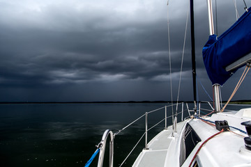 Fototapeta premium Sailing concept with boat and lake water storm weather