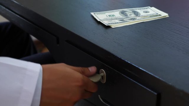 Corruption, bribery and fraud are. a close-up of a doctor taking money. 4k . slow motion