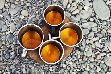 Four mugs with drink in sea coast.