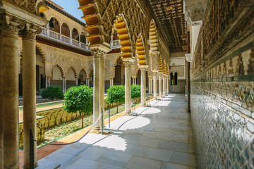 Palace of Alcazar, Famous Andalusian Architecture. Old Arab Palace in Seville, Spain. Ornamented Arch and Column. Famous travel destination.