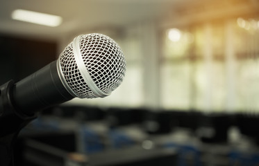 Microphone on abstract blurred of speech in seminar room or speaking conference hall light, computer bokeh background