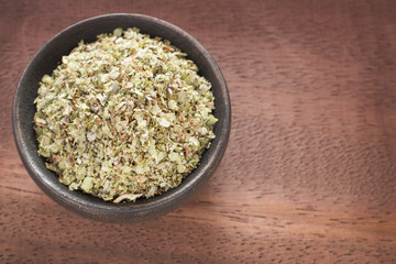 Fresh and dried oregano herb on wooden background - Origanum vulgare