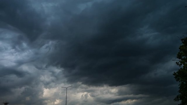 Massive huge dark clouds before the summer thunderstorm. Very rapid movement of clouds in the sky. Time lapse of dark sky during rain
