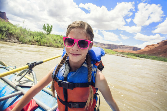 Young girl having fun on a river rafting trip down the Colorado River 
