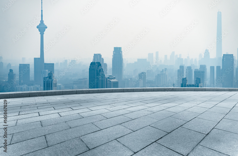 Wall mural empty square front of tianjin city skyline with landmark TV tower in the fog,china.