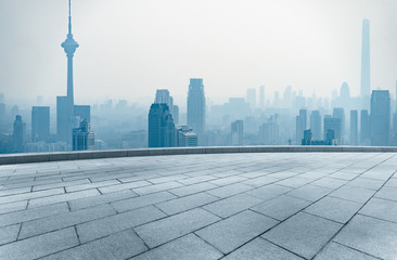 empty square front of tianjin city skyline with landmark TV tower in the fog,china.