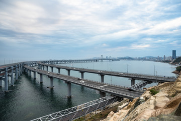Fototapeta na wymiar Dalian Cross-Sea Bridge against cloudy sky,China.