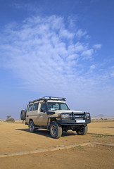 Fototapeta na wymiar Safari transport in the plain of Serengeti, Tanzania