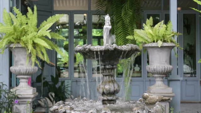 Vintage fountain in coffee shop garden, stock video